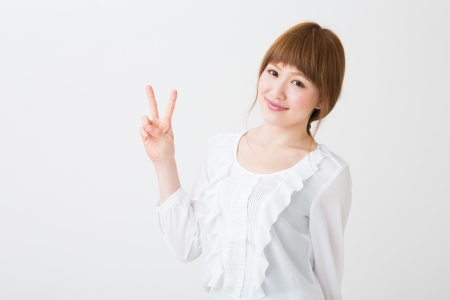 young attractive asian woman indicating the number twoの写真素材