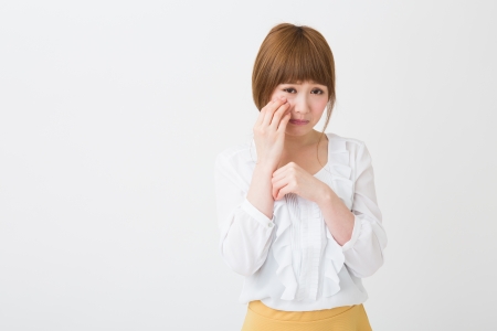young attractive asian woman who criesの写真素材
