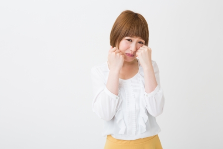 young attractive asian woman who criesの写真素材