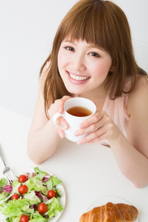 young attractive asian woman who  eatsの写真素材