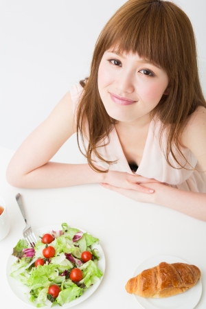 young attractive asian woman who  eatsの写真素材