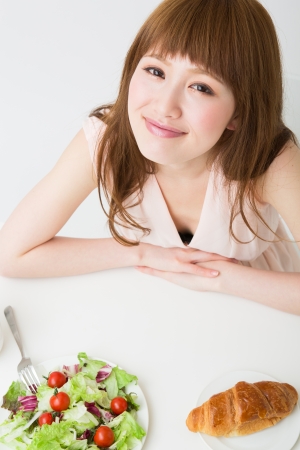 young attractive asian woman who  eatsの写真素材