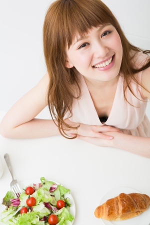 young attractive asian woman who  eatsの写真素材