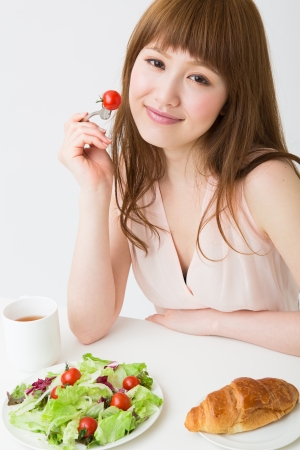 young attractive asian woman who  eatsの写真素材