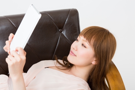 Beautiful young asian woman using tablet computerの写真素材
