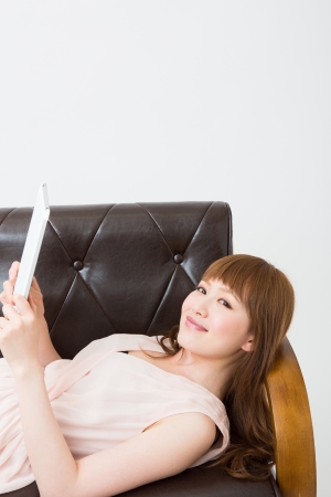 Beautiful young asian woman using tablet computerの写真素材
