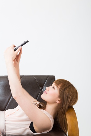 The Young woman who uses the smartphone in a roomの写真素材