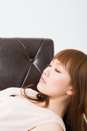 young woman who lies in the sofaの写真素材