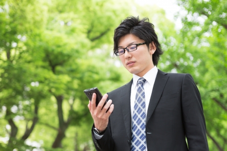 Young businessman to see a smart phoneの写真素材