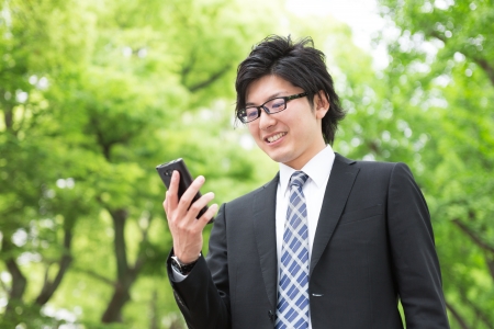 Young businessman to see a smart phoneの写真素材