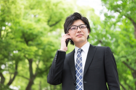 Young businessman who talks on the telephoneの写真素材