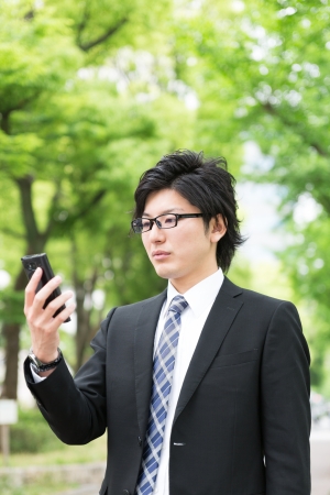 Young businessman to see a smart phoneの写真素材