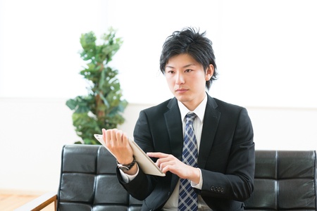young businessman using tablet computerの写真素材