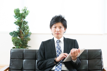 young businessman using tablet computerの写真素材