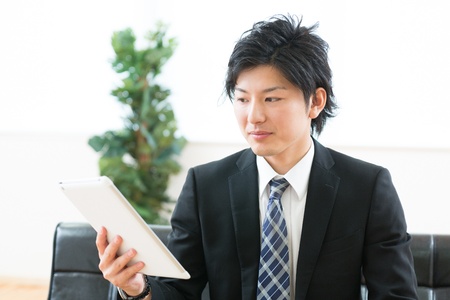 young businessman using tablet computerの写真素材