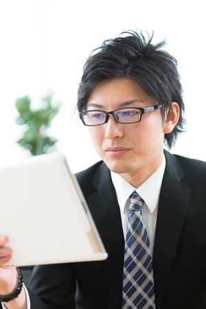 young businessman using tablet computerの写真素材