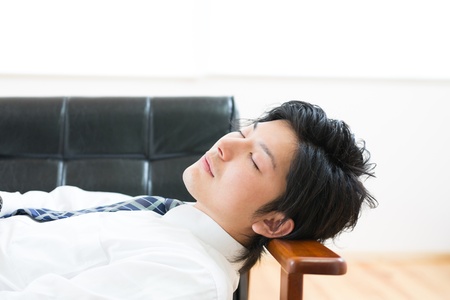 businessman who lies in the sofaの写真素材