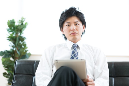 young businessman using tablet computerの写真素材