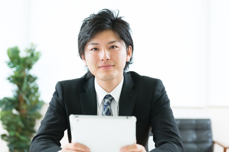 young businessman using tablet computerの写真素材