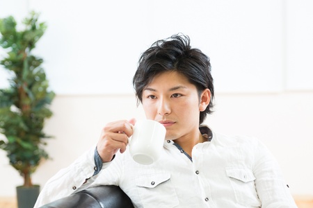 young man who takes a drinkの写真素材