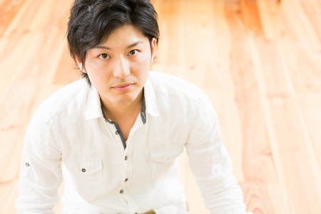 young man who sits on the floorの写真素材
