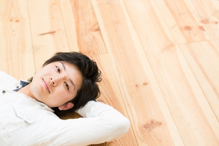 young man who lies on the floorの写真素材
