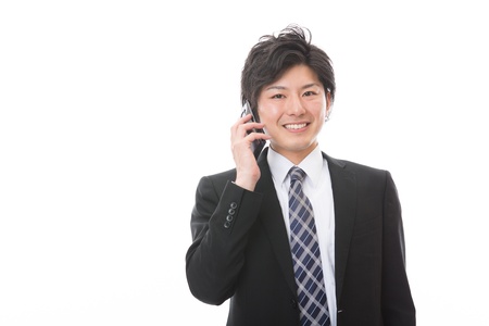 The Young businessman who talks on the telephoneの写真素材
