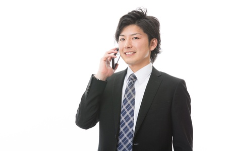 The Young businessman who talks on the telephoneの写真素材