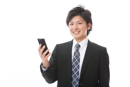 Young businessman to see a smart phoneの写真素材