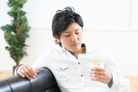 young man who drinks wineの写真素材