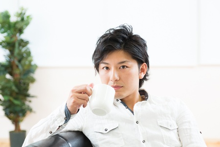 young man who takes a drinkの写真素材