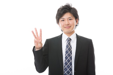 businessman indicating the number threeの写真素材