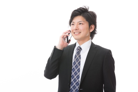 The Young businessman who talks on the telephoneの写真素材