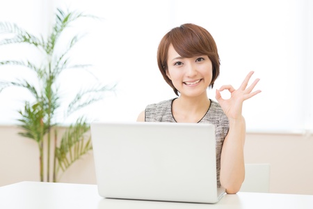 Beautiful young asian woman using laptopの写真素材