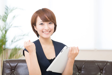 Beautiful young asian woman using tablet computerの写真素材