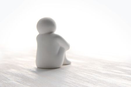 People who sit and think, those who are pensive. (white dolls) Inactive person.の写真素材