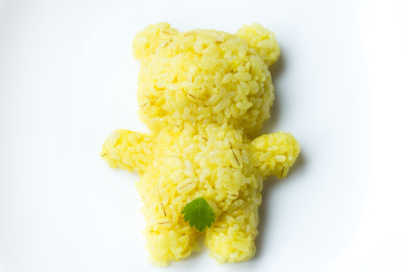 Bear shaped turmeric rice with a leaf on his crotchの写真素材
