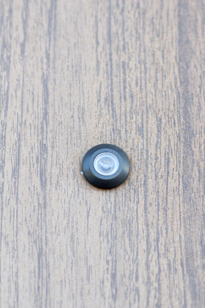 A spy hole on the wooden entrance doorの写真素材