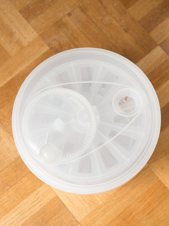 Top view of clear plastic vegetable spinner on wooden tableの写真素材