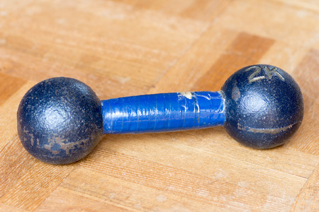 metal small light dumbbell on the wooden floorの写真素材