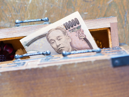 Hiding Japanese money in an antque miniture drawer called Tansu Yokin in Japaneseの写真素材
