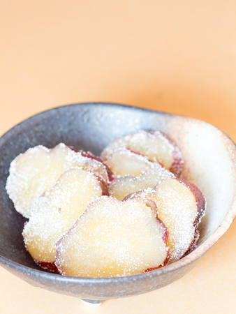 Japanese cuisine, sugar glazed sweetened sweet potato called Amanatto on the tableの写真素材