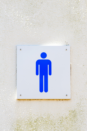 Male gender sign of bathroom on the wallの写真素材