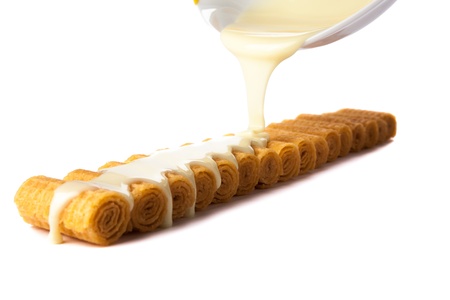 number of rolls under the condensed milk on a white backgroundの写真素材