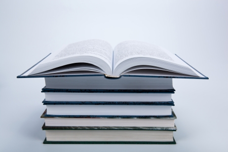 open book on a pile of books isolatedの写真素材