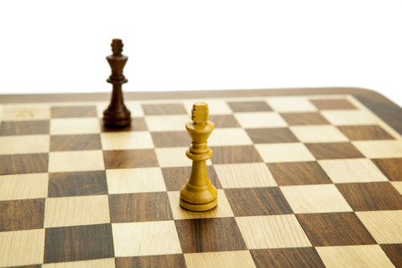 chess pieces on the board on white backgroundの写真素材