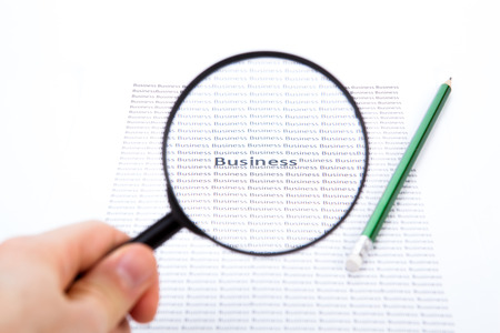 Magnifier, pencil and paper close-upの写真素材