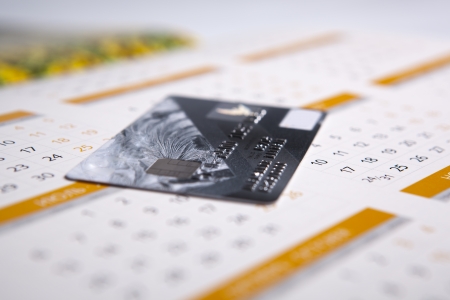 bank card lying on the calendar close-upの写真素材