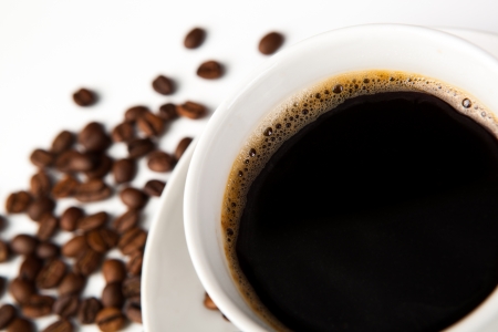 cup of black coffee and roasted coffe beans close-upの写真素材