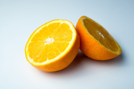 two half slices of orange close-up on greyの写真素材